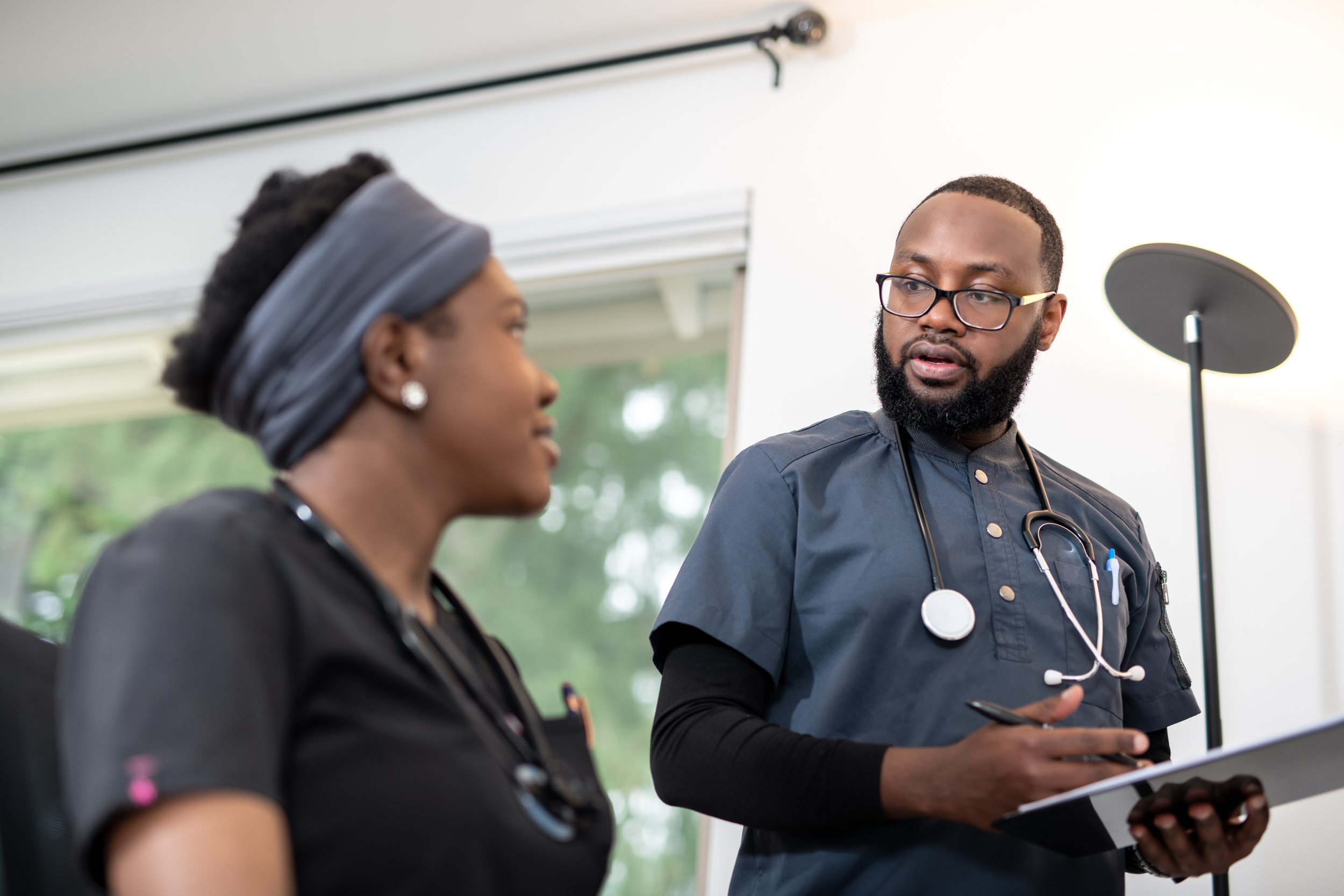 Healthcare team discussing care coordination - professional dedicated staff