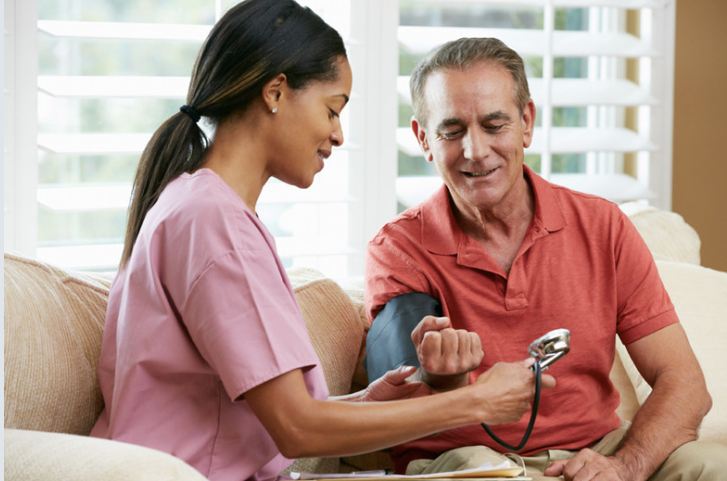 Nurse checking blood pressure - cardiovascular monitoring care
